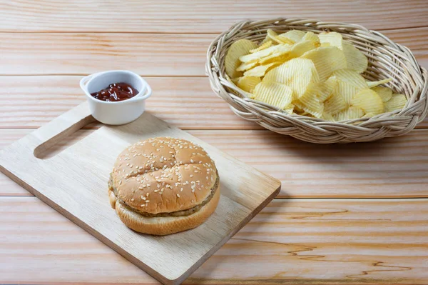 Ketçaplı, az yağlı hamburger ve patates cipsi. Yemeye hazır..