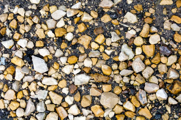 El fondo de gravas, hay un montón de gravas que diferentes formas y colores en el suelo . —  Fotos de Stock