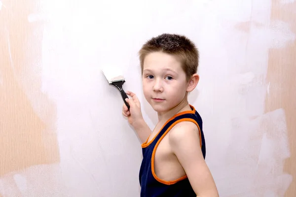 Boy Blue Shirt Paints Interior Wall Apartment White Looks Camera — Stock Photo, Image