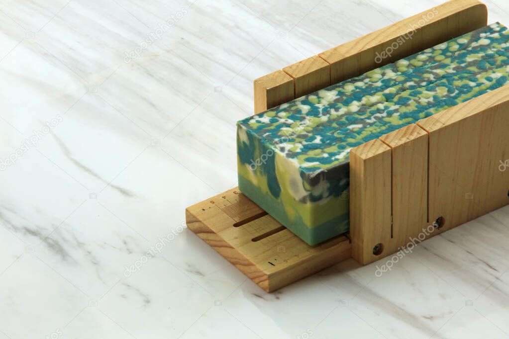 Handcrafted drop swirl design soap displayed on marble surface