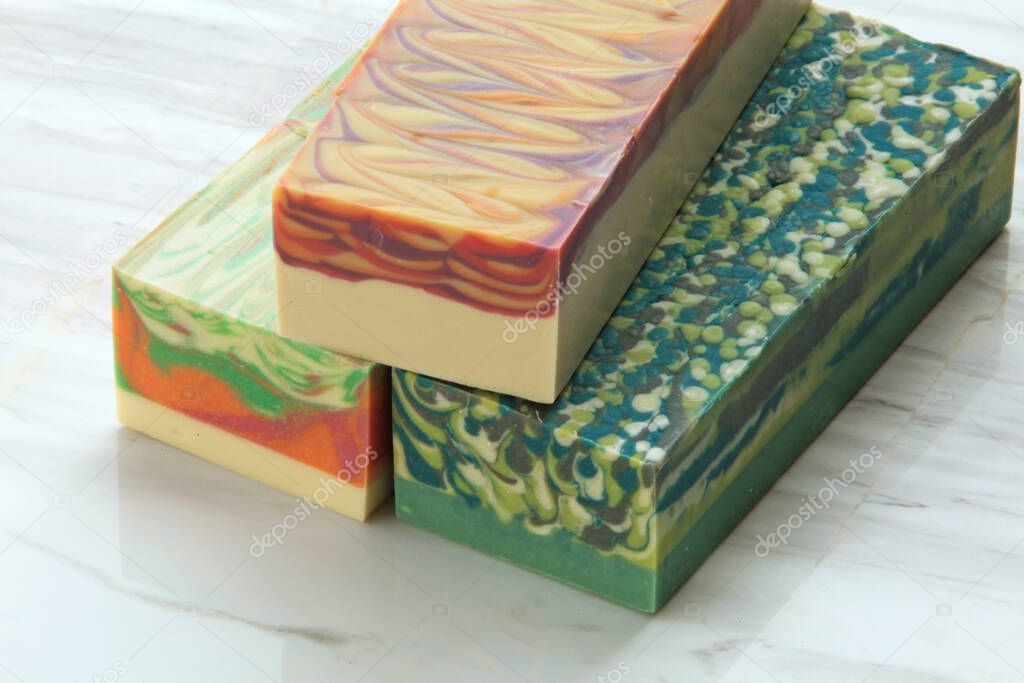Block of cold process soap on linen backdrop