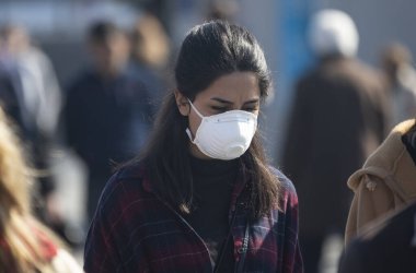 Istanbul, Turkey, 11 March 2020, A woman wearing his face due to due to coronavirus (COVID-19) epidemic around the world walks. clipart