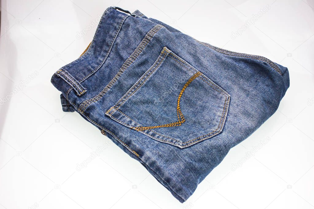 Closeup shot of blue denim jeans on white background