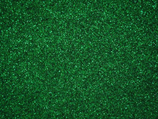 A glittery green paper. Silver glitter light bokeh abstract texture. Pattern designs. Sparkle wallpaper for Christmas. Brilliance shimmering sequin background. Party time.