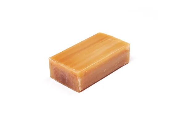 Universal antibacterial natural laundry soap. Brown bar of natural soap Isolated on a white background.