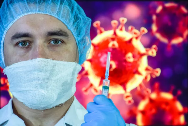 A man in a mask and protective gloves on the background of the image of a coronavirus. Doctor with a vaccine and a syringe.
