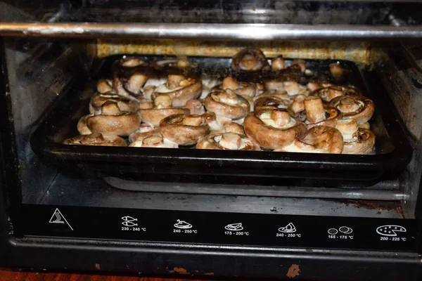 Baking mushrooms in an electric oven. Mushrooms are baked in the oven.