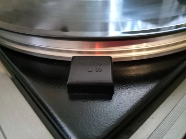 Vinyl player. The plate is on the vinyl player. A strobe effect to control the speed of the vinyl record.