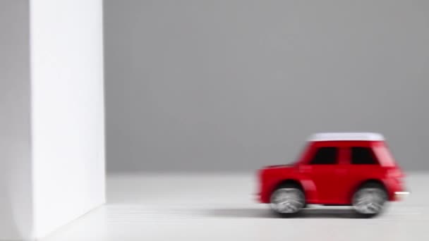 Czerwony model rozbija się o ścianę. Zderzenie czołowe pojazdu ze ścianą — Wideo stockowe