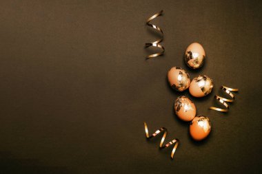 Koyu arkaplanda altın tavuk yumurtası. Mutlu Paskalyalar