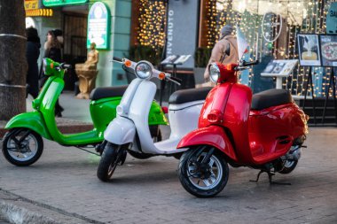 Three vintage scooter Italian flag colors parked on a city street on old street in Odessa