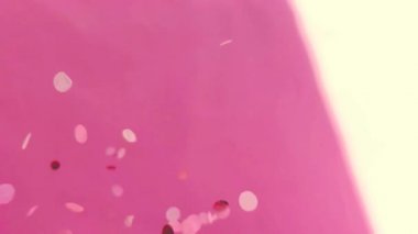 Colored confetti sequins fall. Holiday Vertical Video