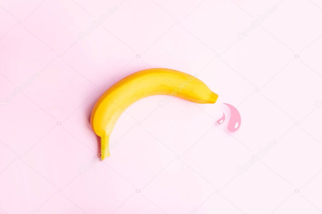 Premature ejaculation contraception concept. Big yellow banana and drops of liquid.