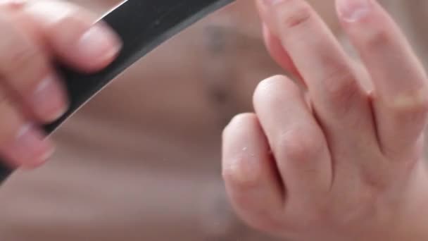 Close up of woman polishing fingernails with the nail file. Body care, manicure — Stock Video