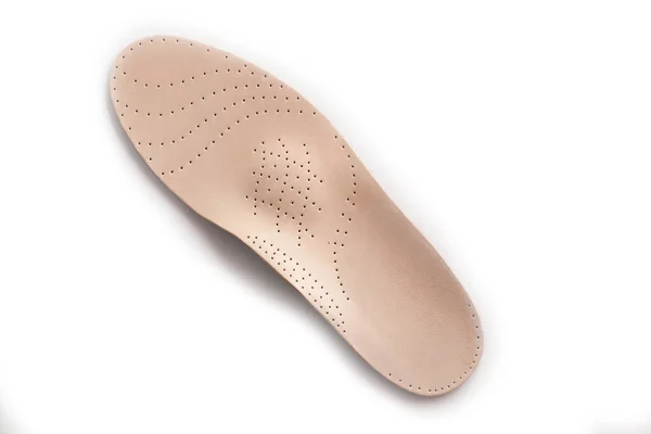 Isolated orthopedic insole on a white background. Treatment and prevention of flat feet and foot diseases. Foot care, comfort for the feet. Wear comfortable shoes. Medical insoles.