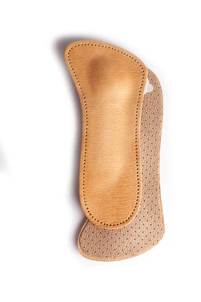 Isolated orthopedic insole on a white background. Treatment and prevention of flat feet and foot diseases. Foot care, comfort for the feet. Wear comfortable shoes. Medical insoles.