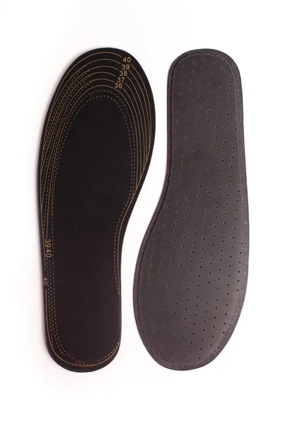 Isolated orthopedic insole on a white background. Treatment and prevention of flat feet and foot diseases. Foot care, comfort for the feet. Wear comfortable shoes. Medical insoles.