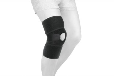 Diz Destek Kolu beyaz arka planda izole edilmiş bir bacak üzerinde. Ortopedik Anatomik Ortopedi. Diz sabitleme, yaralanma ve ağrı için diş telleri. Ortopedi. Ayak ortozu. Diz eklemi bandaj kolu. Elastik Spor 