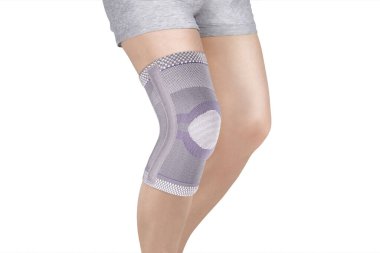 Diz Destek Kolu beyaz arka planda izole edilmiş bir bacak üzerinde. Ortopedik Anatomik Ortopedi. Diz sabitleme, yaralanma ve ağrı için diş telleri. Ortopedi. Ayak ortozu. Diz eklemi bandaj kolu. Elastik Spor 