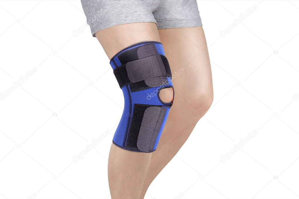 Knee Support Brace on leg isolated on white background. Orthopedic Anatomic Orthosis. Braces for knee fixation, injuries and pain. Orthotics. Foot orthosis. Knee Joint Bandage Sleeve. Elastic Sports 