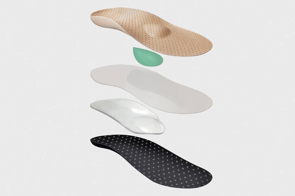 Isolated orthopedic insole on a white background. Treatment and prevention of flat feet and foot diseases. Foot care, comfort for the feet. Wear comfortable shoes. Medical insoles.