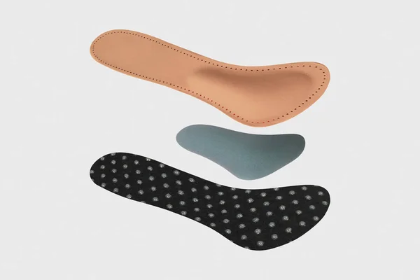 Isolated orthopedic insole on a white background. Treatment and prevention of flat feet and foot diseases. Foot care, comfort for the feet. Wear comfortable shoes. Medical insoles.