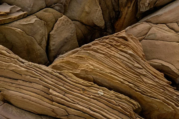 Kum taşı dokusunu kapatın, doğal yüzey. Tema jeolojisi arkaplanı