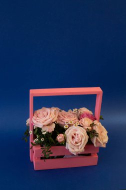 Kartpostal şablonu, kopyala Boşluk - mavi arkaplanda pembe güllerle dolu bir sepet
