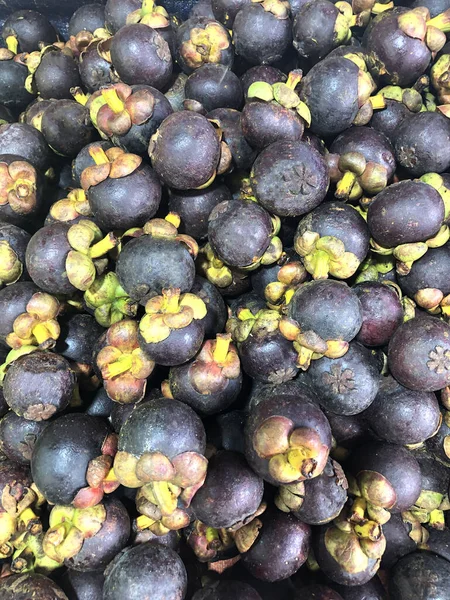 photo tropical mangosteen fruit on the counter of the supermarket