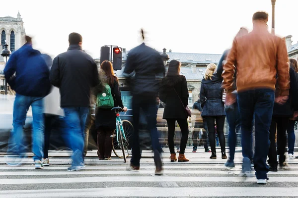 Multitud de personas cruzando una calle de la ciudad — Foto de Stock