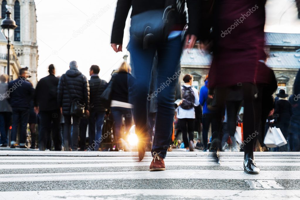 crowd of people crossing a city street