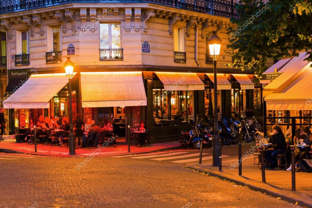 Street cafes on the Ile Saint Louis in Paris at night Stock Editorial