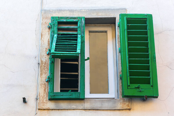 Old shuttered window at a house in Florence, Italy