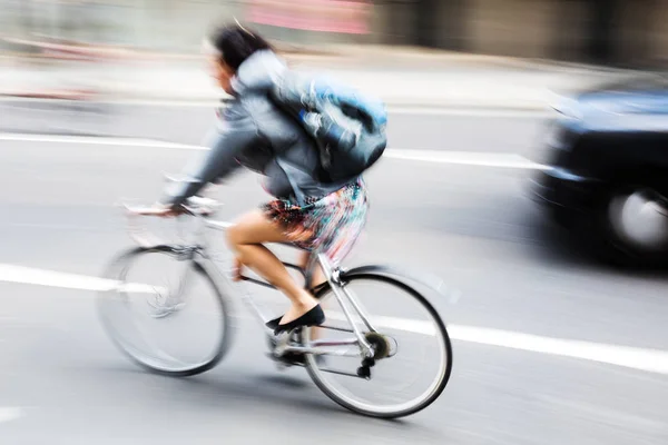 Woman with bicycle in city traffic — Stock Photo, Image