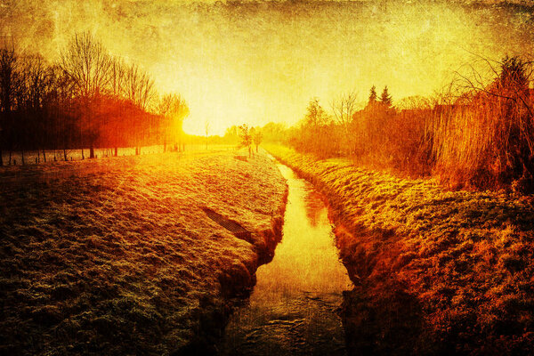 Picture of a sunset over a rural landscape with grunge texture