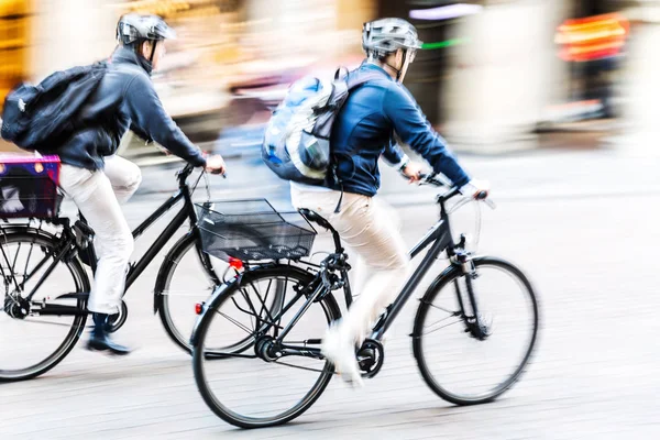 bicycle riders in city traffic in motion blur