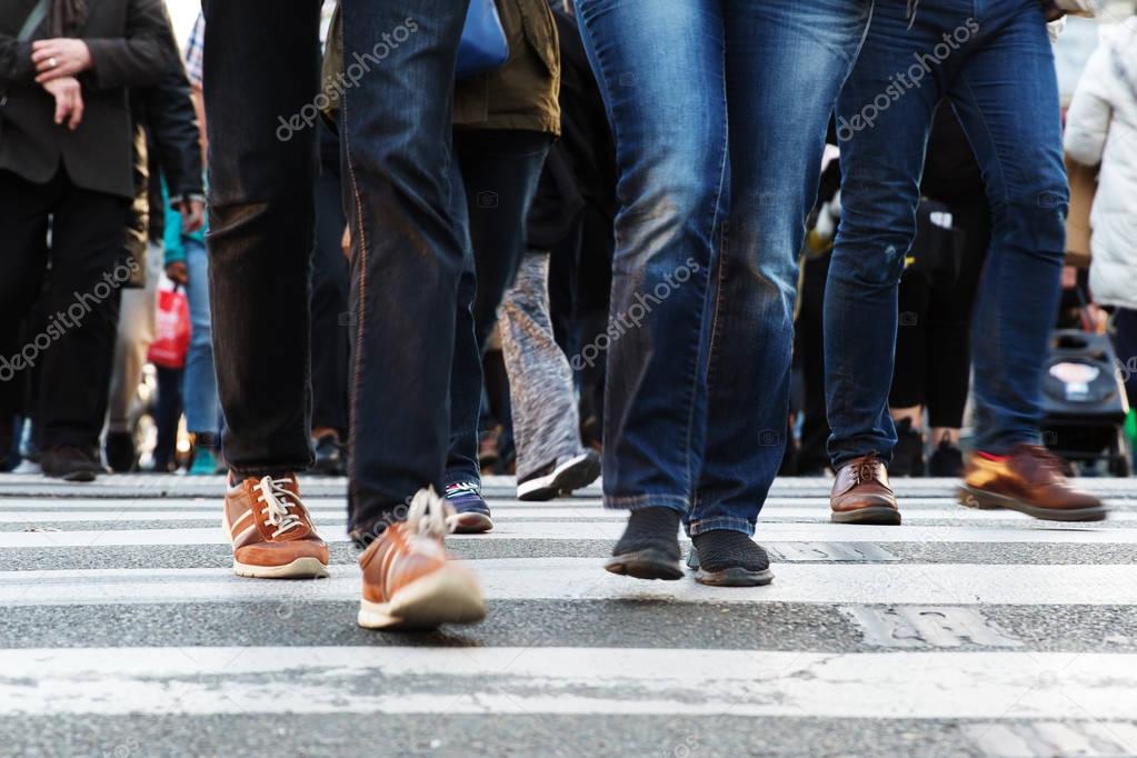 legs of people crossing a street