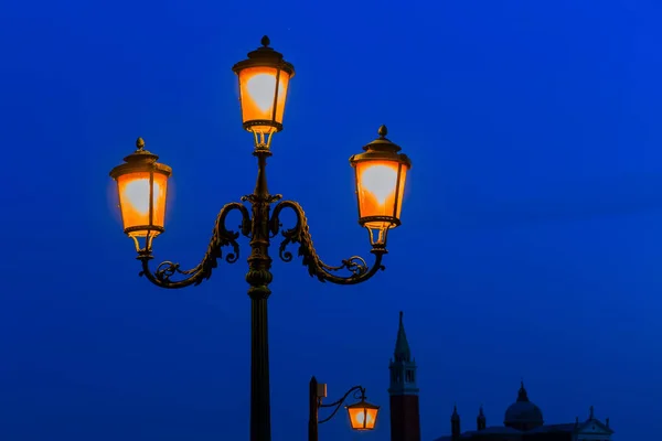 old street lamp at night in Venice, Italy