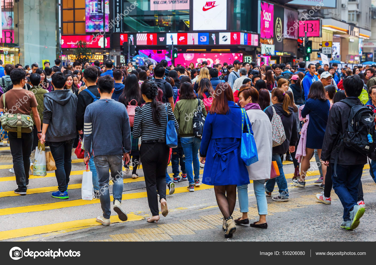 Crowds of people crossing King's Road in Hong Kong Stock Editorial