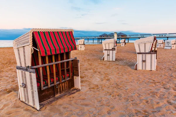 Pier of Heringsdorf, Germany, with hooded beach chairs — Stock Photo, Image