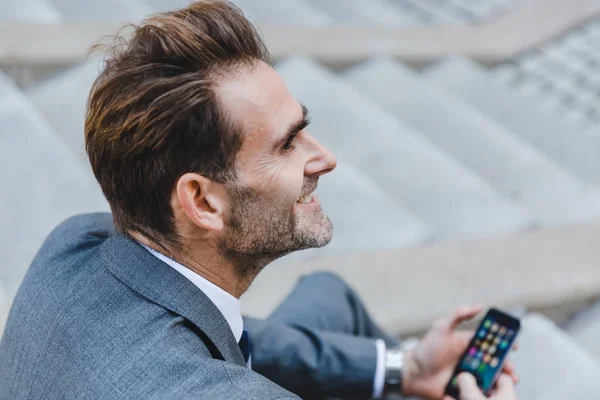 businessman sitting on stairs in an office park