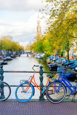 Bisikletler Hollanda, Amsterdam 'da bir köprünün tırabzanına park ediyor.