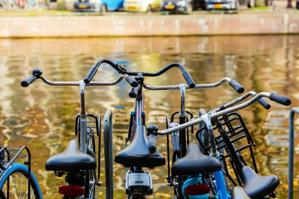 オランダのアムステルダムの運河の横に停められた自転車の写真 — ストック写真