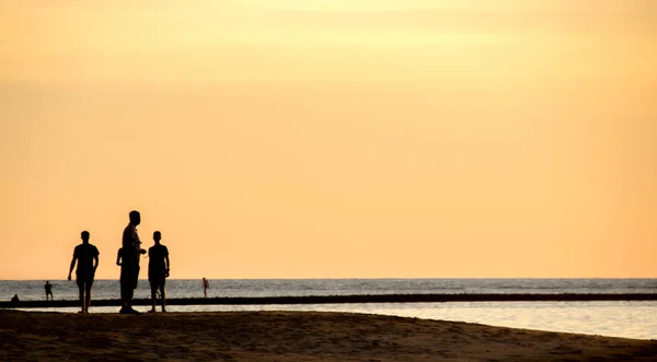 silhouette tourism man group on the beach