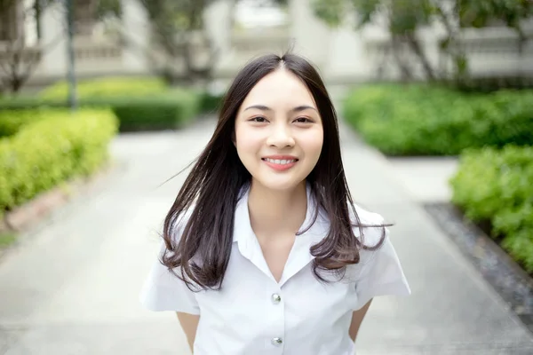 sharming teenage asian girl smiling on university student unifor