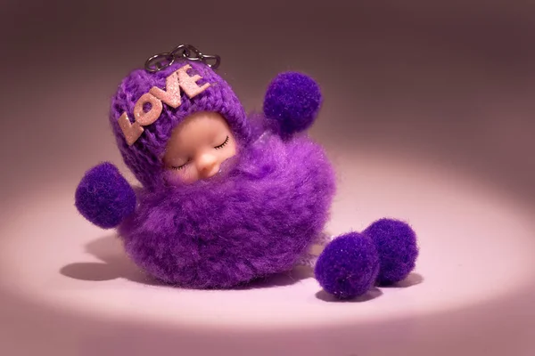 Muska, tılsım aşk yazıtlı iyi şans tılsımı. Yumuşak, uyuyan mor bir bebek. Boşluğu kopyala