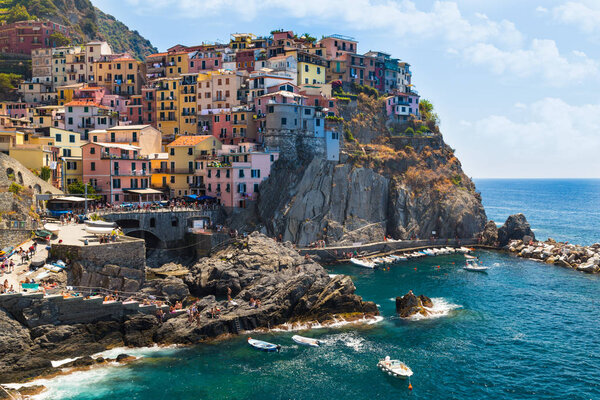 View of the colorful houses of ancient city of Manarola and the coast, Italy. Cinque Terre National Park, Ligurian Riviera, UNESCO World Heritage Site. Tourist sight. View fro