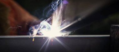 Kaynakçılar inşaat halindeki bina yapısını bağlar.