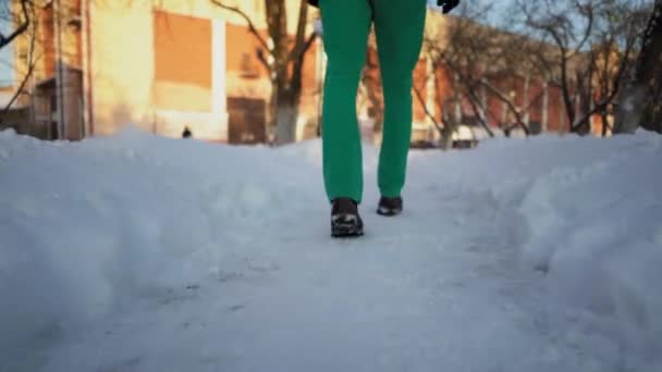 Κοντινό πλάνο για τα πόδια Mans όπως ο ίδιος περπατώντας σε ένα χιονισμένο δρομάκι στο πάρκο — Αρχείο Βίντεο