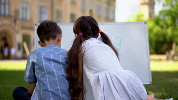 Children playing outdoors studdying mathematics — Stock Video